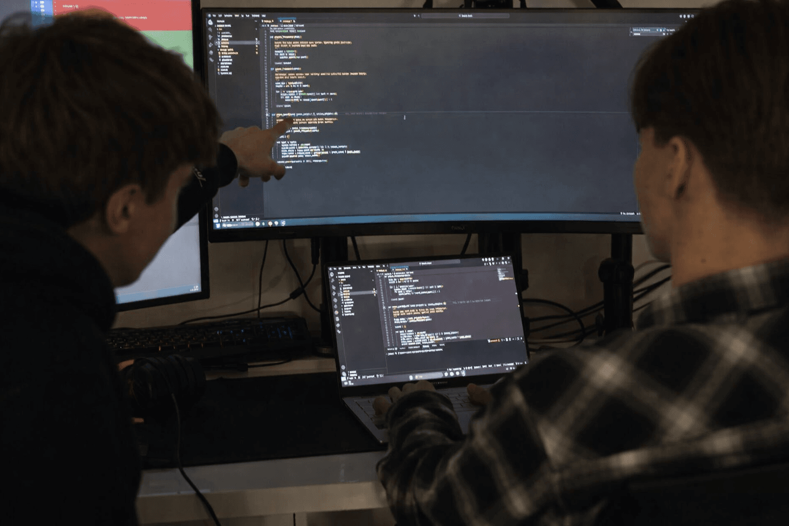 Professional development team collaborating on software project with modern office setup